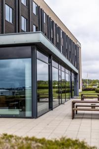 a building with two benches in front of it at Airport Hotel, Billund in Billund