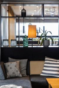 a living room with a couch and a window at Airport Hotel, Billund in Billund
