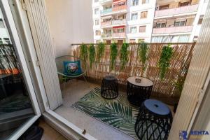 a balcony with three chairs and a table and a building at Chambre 2 René Cassinbalcon Wifi Mini-frigo TV in Nice