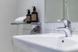 a bathroom with two bottles of wine on a sink at Airport Hotel, Billund in Billund