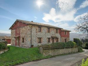 a large stone house with a red roof at Apartamentos Rurales El Mirador de Cazanes in Cazanes