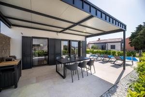 an open patio with a table and chairs at Villa Bella in Klimno