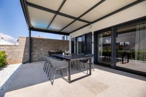 an outdoor patio with a table and chairs at Villa Bella in Klimno