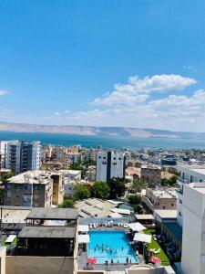 a view of a city with a large swimming pool at Ben house in Tiberias