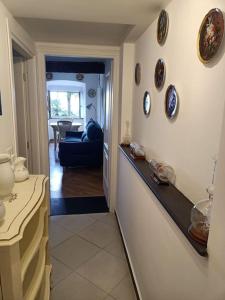 a hallway of a home with plates on the wall at Casetta Jacaranda in Genova