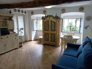 a living room with a blue couch and a table at Casetta Jacaranda in Genoa