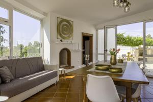a living room with a couch and a table at Villa Gina in Capilungo