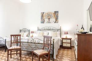 a bedroom with a bed and two chairs at Villa Gina in Capilungo +74 photos