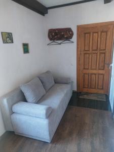 a living room with a couch and a door at Готель "ГОСТЬОВИЙ ДІМ in Stryj" in Stryi