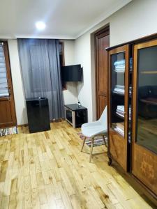 uma sala de estar com uma cadeira e um armário em Guest house Agmashenebeli 229 em Kobuleti