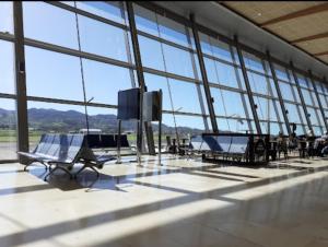 a large room with tables and chairs in a building with large windows at Viajeros in La Laguna