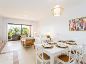 埃斯特波納的住宿－Mediterranean Swing - Royal Flamingos I Apartment，客厅配有白色的桌子和椅子