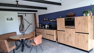 a kitchen with wooden cabinets and a table and chairs at Woning in Born in Born