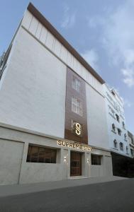 un edificio con un signo supremo a su lado en SUPREME STAY en Chennai