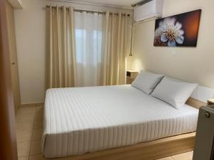 Ένα ή περισσότερα κρεβάτια σε δωμάτιο στο Garden View Apartment