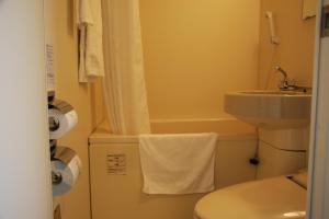 Baño pequeño con aseo y lavamanos en Hotel Route-Inn Sapporo Chuo, en Sapporo