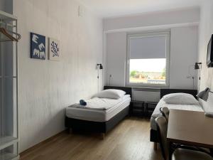 a bedroom with two beds and a window at Premium Hostel & Bistro in Mielec