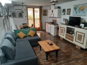 a living room with a couch and a coffee table at Les Chambres Chouettes in Villefranche-de-Conflent