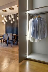a closet with a shirt hanging in a room at ICONIC SALONICA SUITE seafront in Thessaloniki