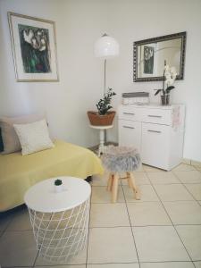 a living room with a bed and a table at Apartments Prosperina Hvar in Hvar