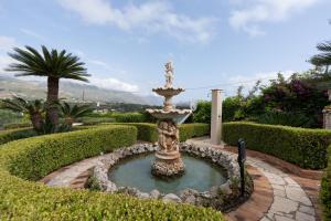 a fountain in the middle of a garden at Casa Blu in Castellammare del Golfo