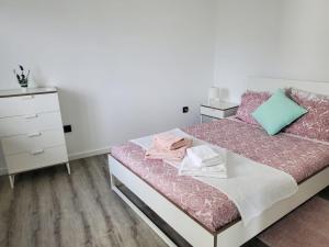 a bedroom with a bed and a dresser at Douro Mesio Guest House in Resende