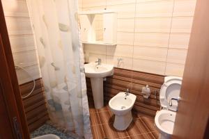 a small bathroom with a toilet and a sink at Iris apartaments in Sakës +63 photos