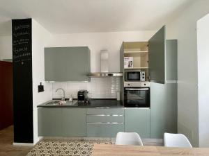 a kitchen with green cabinets and a stove top oven at Asso Asso in Guardiagrele