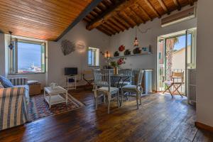 a living room with a table and chairs at Loft il Mare Rio Marina front sea in Rio Marina