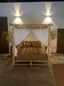 a bed with a canopy in a room at Magnifique villa sans vis-à-vis • Marrakech in Marrakech +55 photos