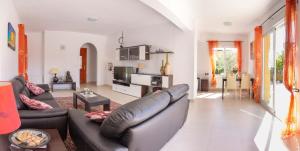 a living room with a couch and a table at Casa Piña met jaccuzi in Mazarrón +12 photos