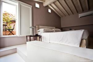 a bedroom with a bed and a window at Riva Lofts Florence in Florence