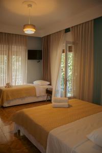 a bedroom with two beds and a window at Amaya Pine Studio in Panagia