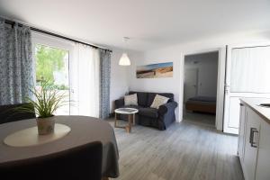 a living room with a couch and a table at Am Küstenwald in Koserow +15 photos