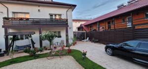 a car parked in a yard next to a house at Casa Sebastian in Costinesti
