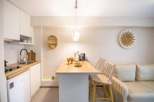 a kitchen and living room with a table and chairs at Casa Iolanda I in Corfu +3 photos