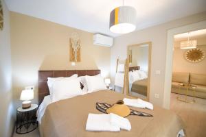 a bedroom with a large bed with a large mirror at Casa Iolanda I in Corfu