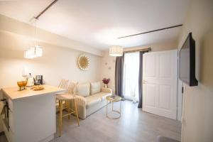 a living room with a white couch and a table at Casa Iolanda I in Corfu