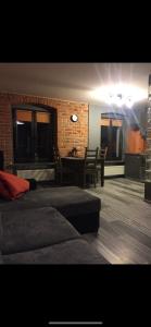 ヴロツワフにあるLoft Wroclawのソファとテーブルが備わるレンガの壁の客室です。