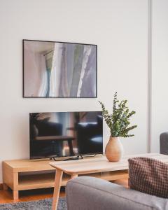a living room with a tv and a table at Cornisa Apartments in Patalavaca