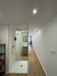 a bathroom with a glass shower and a sink at Unique apartment in Coruña Old Town in A Coruña