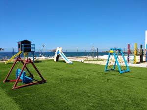 a group of playground equipment on the beach at Caños de Meca Apartamento frente al mar in Los Caños de Meca
