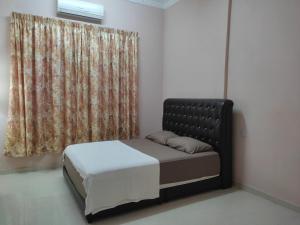Postel nebo postele na pokoji v ubytování Megat Homestay
