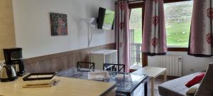 a living room with a glass table and a couch at Apartamentos Grifo Vacances Grizzly in Pas de la Casa