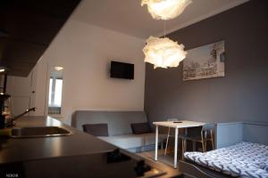 a kitchen and living room with a couch and a table at Apartamenty Kattowitz Słowackiego in Katowice
