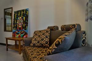 a living room with a couch and a table at Cocolala Beach House in Nungwi