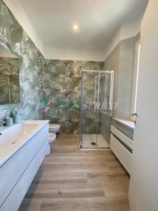 a bathroom with a shower and two sinks and a toilet at Villa Rosy in San Vincenzo +59 photos
