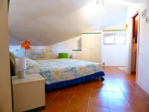 a bedroom with a bed and a tiled floor at La casa di Pane in Follonica