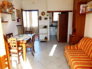 a living room with a table and a couch at La casa di Pane in Follonica