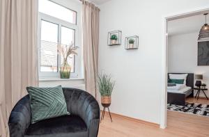 a living room with a leather chair and a mirror at Dream for 4 - Smart TV in Krefeld